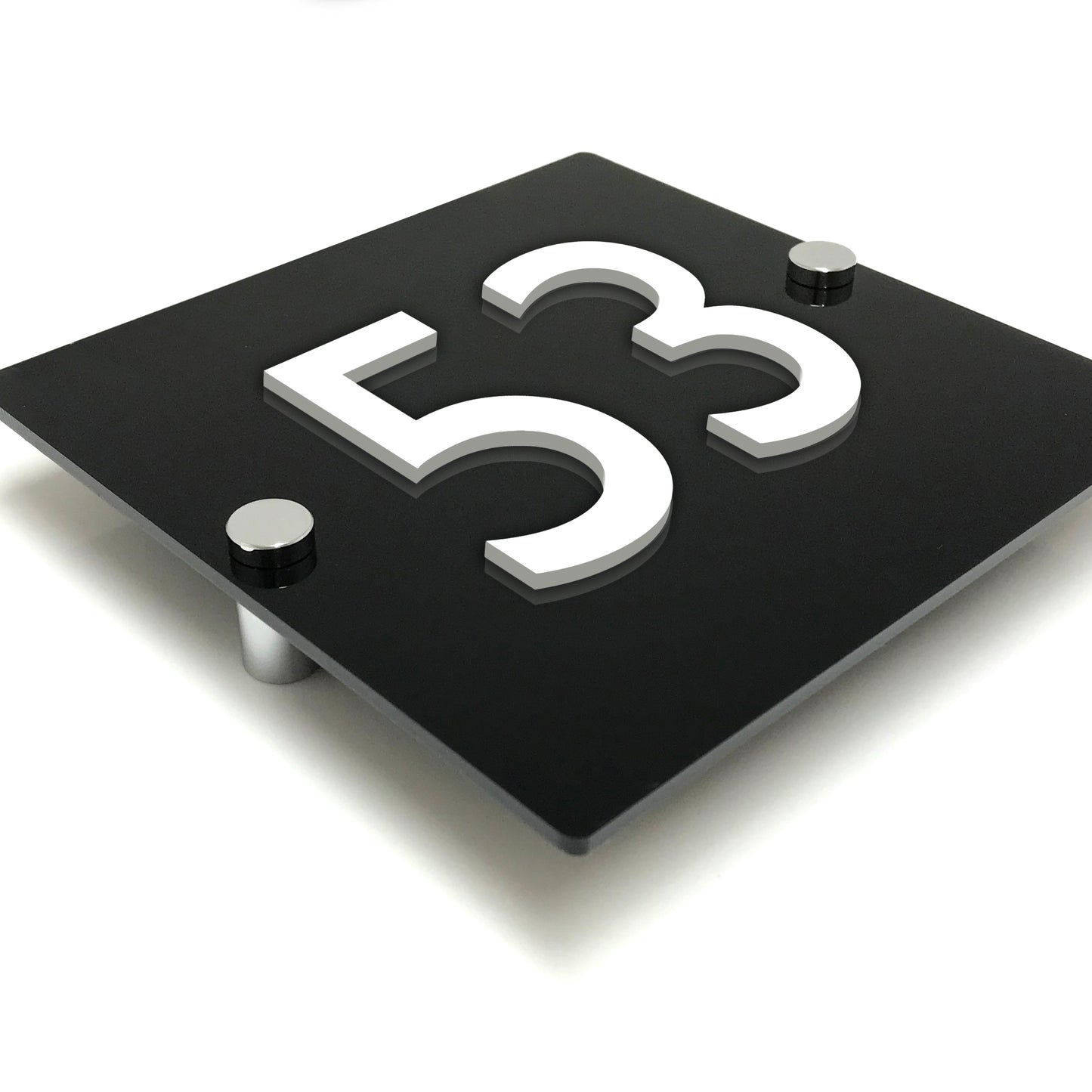 A contemporary and professional looking house number sign designed to be wall mounted. The sign is constructed from gloss black acrylic, has white raised numbers and is intended to be affixed to a wall using stainless steel stand-off fixings.
